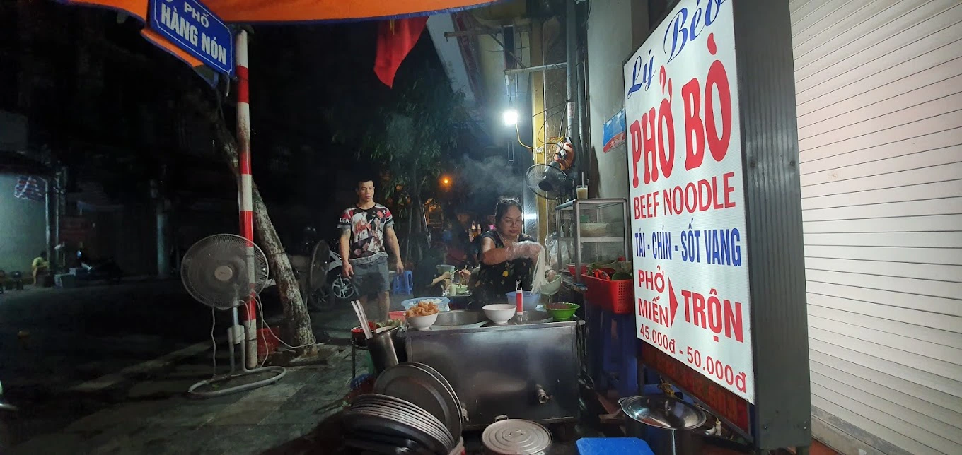 Đây thực chất chỉ là một hàng lưu động, bán buổi tối trên vỉa hè, ngay ngã ba giao giữa Hàng Nón, Hàng Quạt và Hàng Hòm.